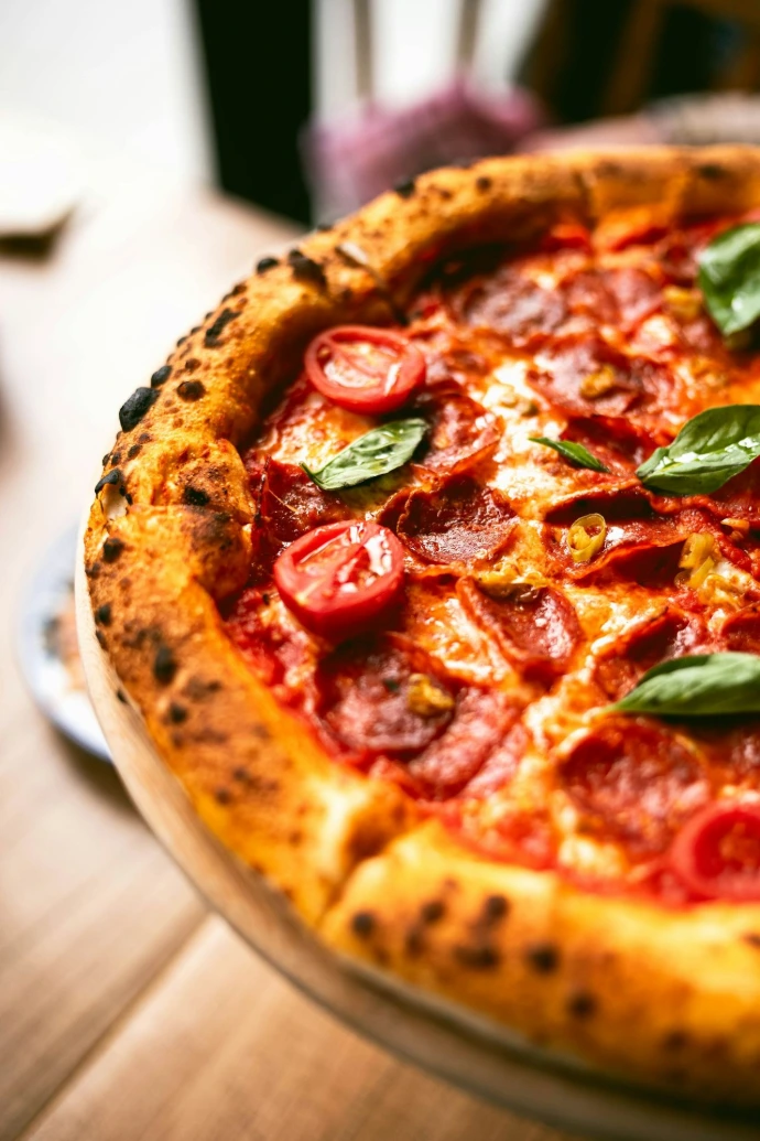 a close up of a pizza on a plate on a table